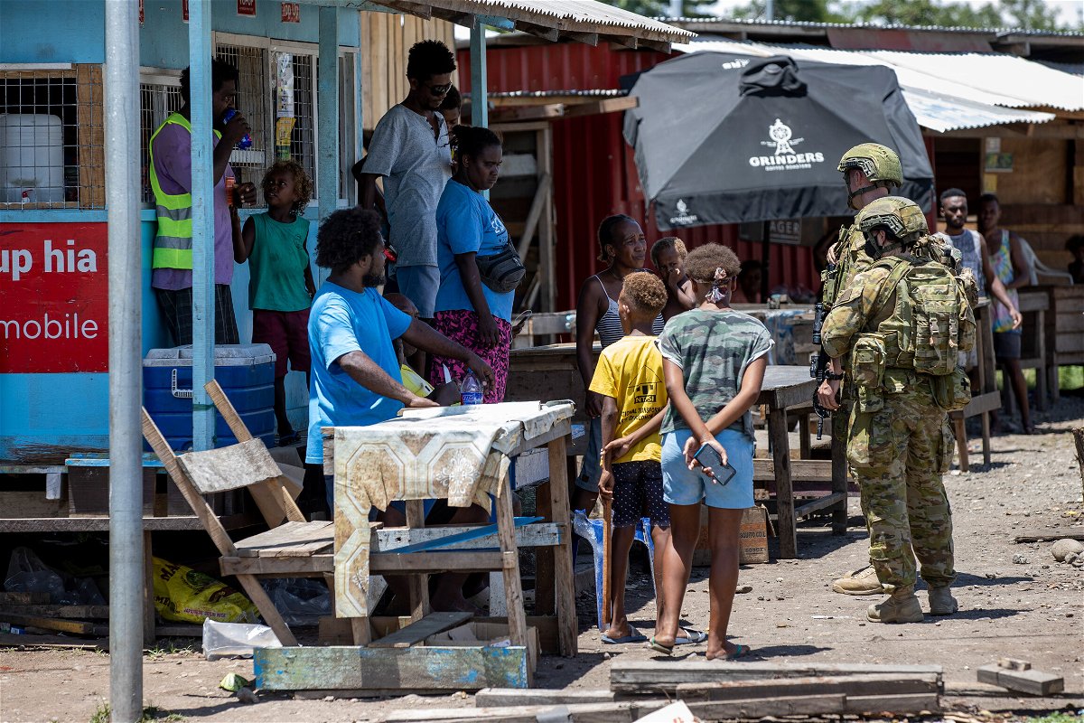 <i>CPL Brandon Grey/Australian Department of Defence/Getty Images</i><br/>Australian Army soldiers talk with locals during a community engagement patrol through Honiara on November 27