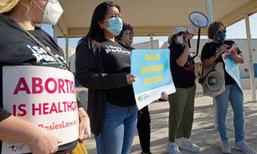 Protesters stand outside the Starr County Jail after a woman was charged with murder for allegedly performing what authorities called a "self-induced abortion" in Rio Grande City