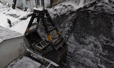 A bucket loads coking coal from the yard at the Moscow coke and gas plant