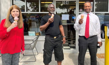 Green poses with attorneys Jeane Thomas and Keith Harrison the day after his release.