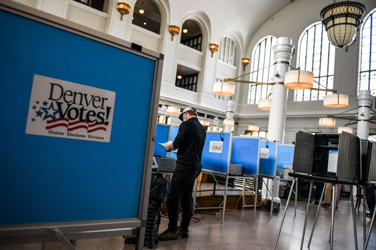 <i>Michael Ciaglo/Getty Images</i><br/>People vote in the primary election at a polling center on June 30