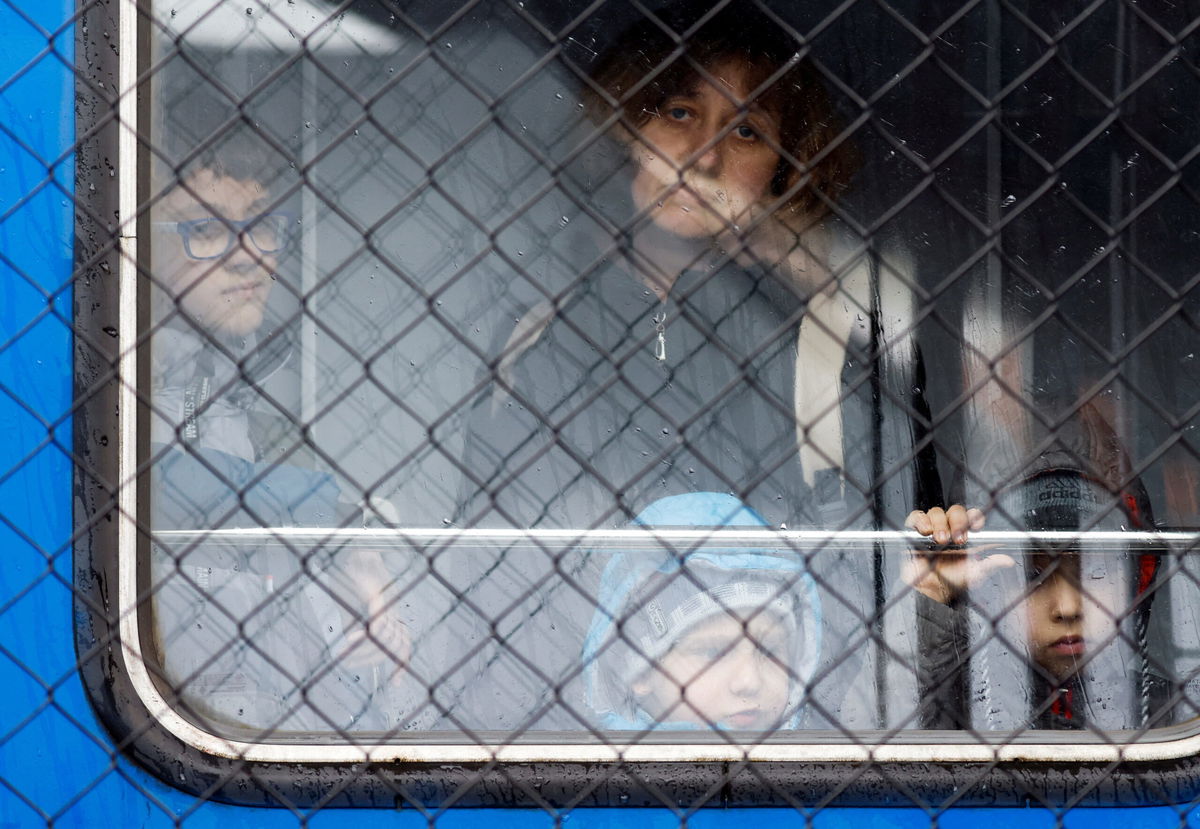 <i>Leonhard Foeger/Reuters</i><br/>Ukrainian refugees look out of a train from Odesa at Przemysl Glowny train station