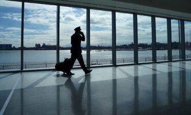 A pilot walks past the windows at the newly renovated Delta terminal D at LaGuardia Airport in New York March 6