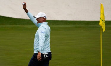 Cink holds up his ball after a hole-in-one on the 16th hole during the second round at the Masters.