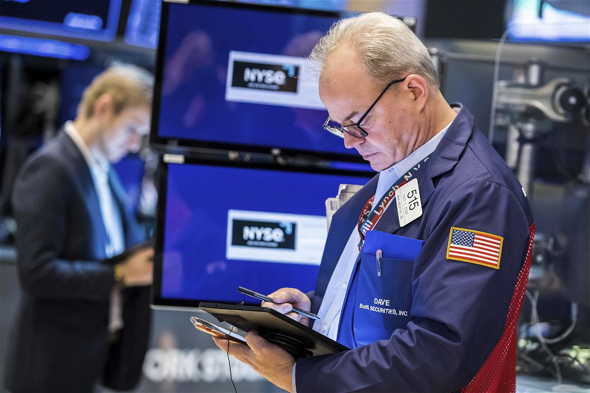 <i>Courtney Crow/New York Stock Exchange/AP</i><br/>Trader David O'Day (R) is seen here working on the floor of the New York Stock Exchange on March 31. Major stock indexes suffered their worst performance in two years in the first quarter of 2022.