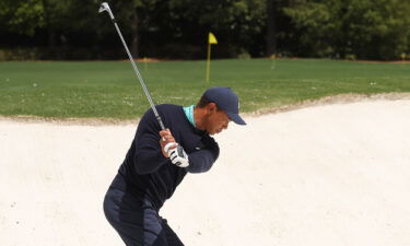 Tiger Woods chips on the practice range before the second round of the Masters Friday in Augusta