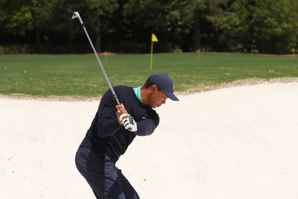 <i>Gregory Shamus/Getty Images North America/Getty Images</i><br/>Tiger Woods chips on the practice range before the second round of the Masters Friday in Augusta