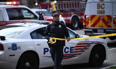 A police officer secures the area after a shooting Friday in northwest Washington