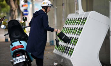 A rider swapping batteries at a Gogoro GoStation in Taipei in 2018. Gogoro