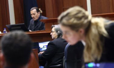 Amber Heard speaks to her legal team as Johnny Depp is on the stand in their defamation trial.