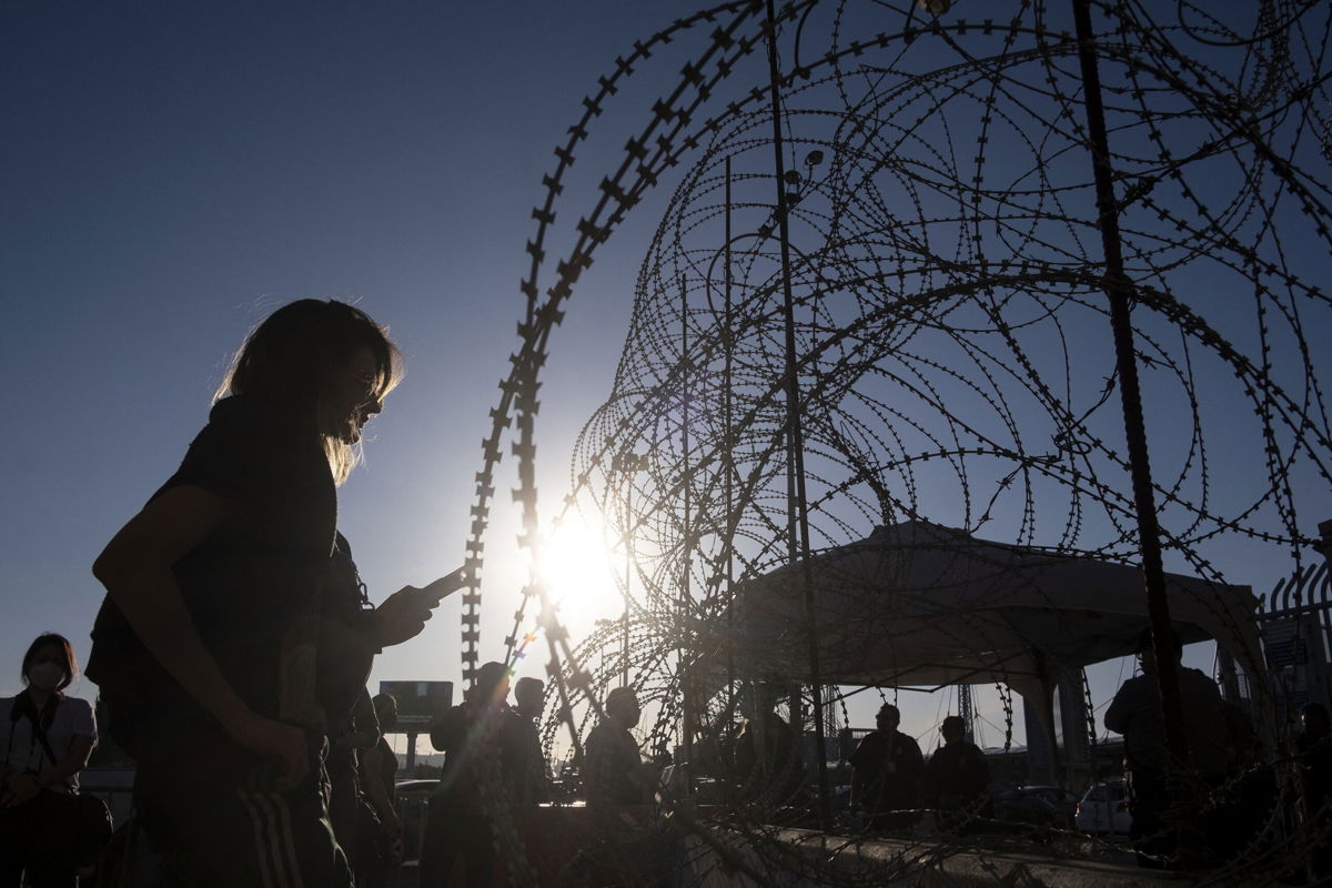 <i>Guillermo Arias/AFP/Getty Images</i><br/>A 21-year-old asylum seeker from Ukraine waits with others from her country for US border authorities to allow them in on the Mexican side of the San Ysidro Crossing port in Tijuana