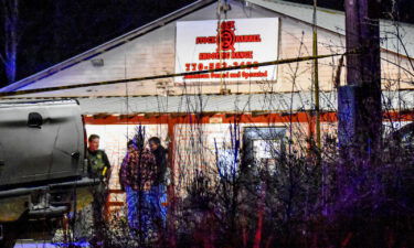 Law enforcement agents are seen outside the Lock Stock & Barrel shooting range where the shooting happened.