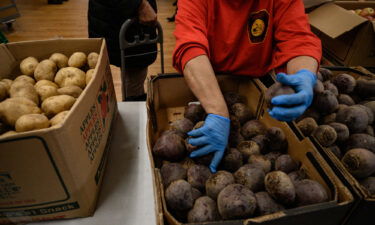 Staff and volunteers at the Hungry Monk food pantry prepare and distribute fruit and vegetables to local residents at their church in Queens