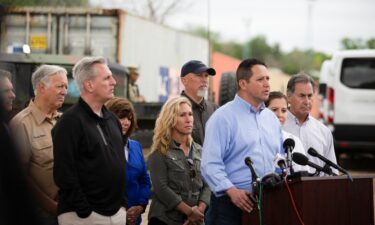 U.S. Rep. Marjorie Taylor Greene (R-GA) watches Rep. Tony Gonzales (R-TX) address the media during a congressional delegation visit to the southern border town of Eagle Pass