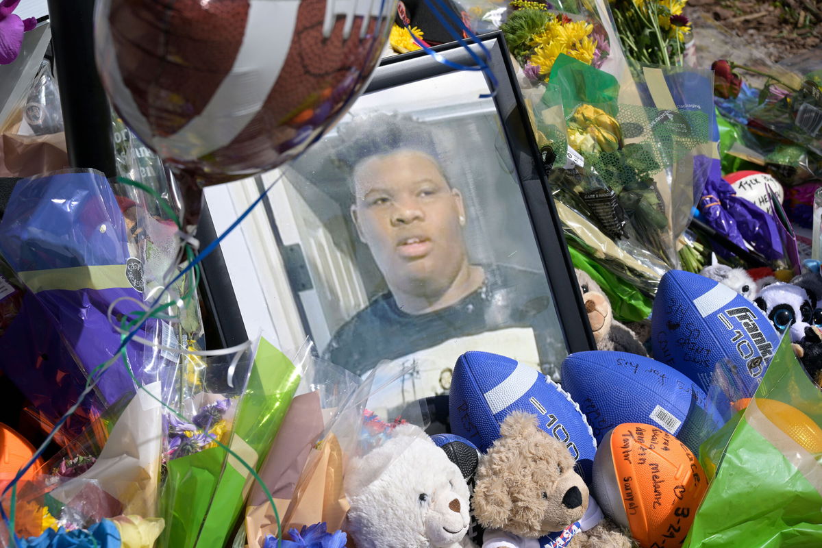 <i>Phelan M. Ebenhack via AP</i><br/>A makeshift memorial for Tyre Sampson is viewed outside the Orlando Free Fall ride at the ICON Park entertainment complex on Sunday