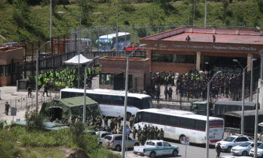 Police and military are seen outside Turi prison on April 4. Ecuadorian authorities said Monday they are in "total control" of the prison after a riot broke out the day before