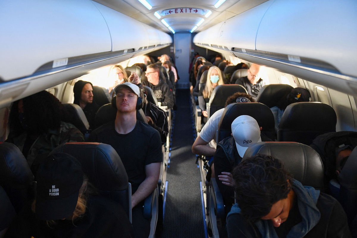 <i>Patrick T. Fallon/AFP/Getty Images</i><br/>Airline passengers sit during an American Airlines flight from Los Angeles International Airport to Denver