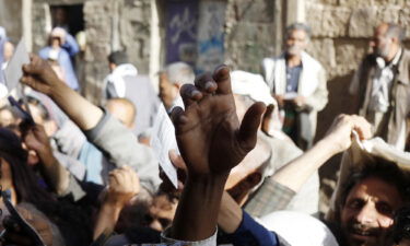 People affected by war wait to receive free meals provided by a charitable kitchen in the Mseek area on April 2 in Sana'a