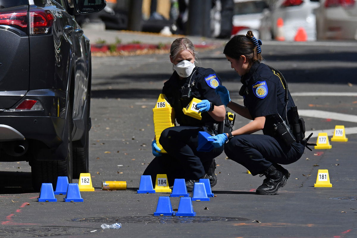 <i>Jose Carlos Fajardo/AP</i><br/>Sacramento Police crime scene investigators place evidence markers on 10th street at the scene of a mass shooting in Sacramento