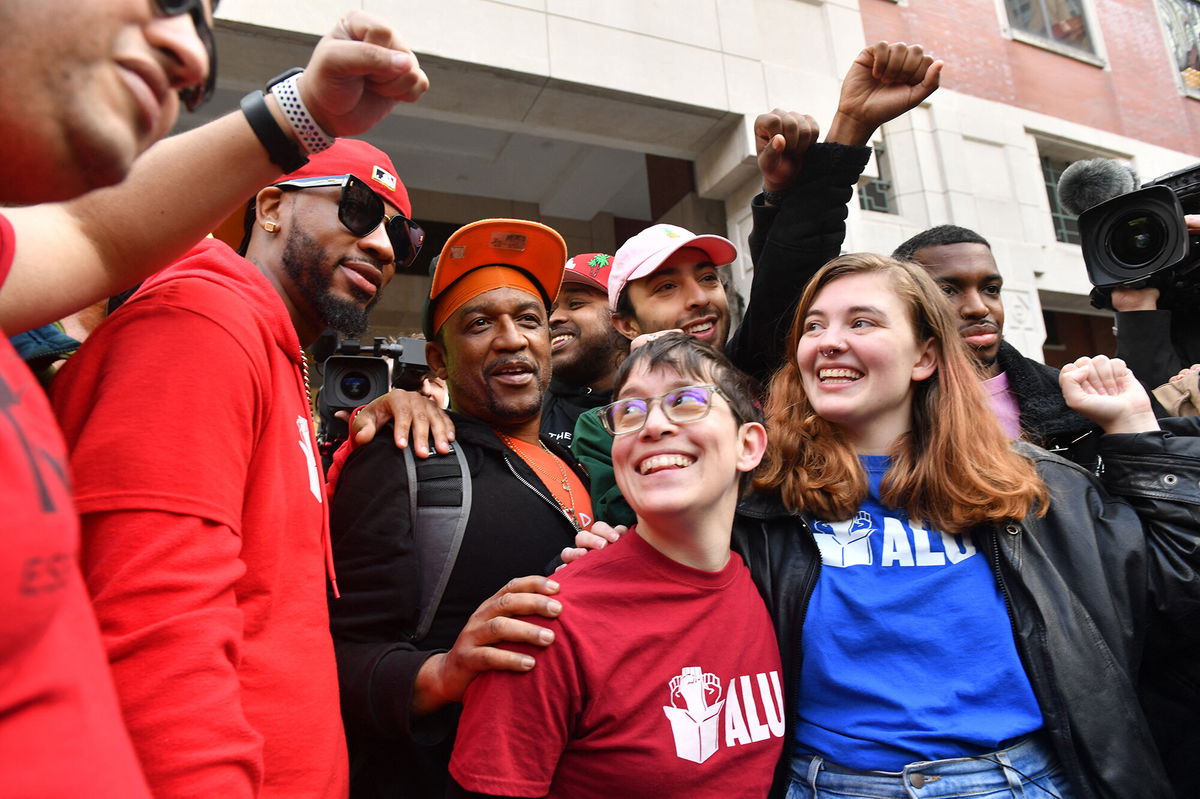 <i>Andrea Renault/AFP/Getty Images</i><br/>Union organizer Christian Smalls (L) celebrates following the April 1 vote for the unionization of the Amazon Staten Island warehouse in New York.