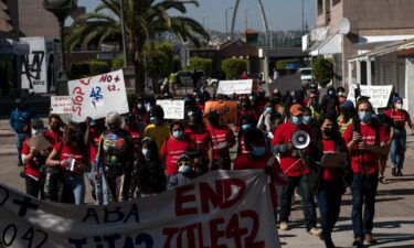 Migrants and asylum seekers march to protest against Title 42 policy in Tijuana