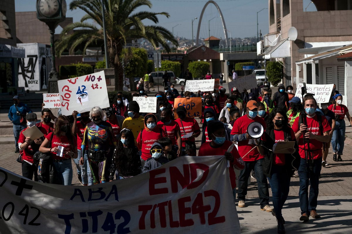 <i>GUILLERMO ARIAS/AFP/Getty Images</i><br/>Migrants and asylum seekers march to protest against Title 42 policy heading to the Mexican side of the San Ysidro Crossing port in Tijuana