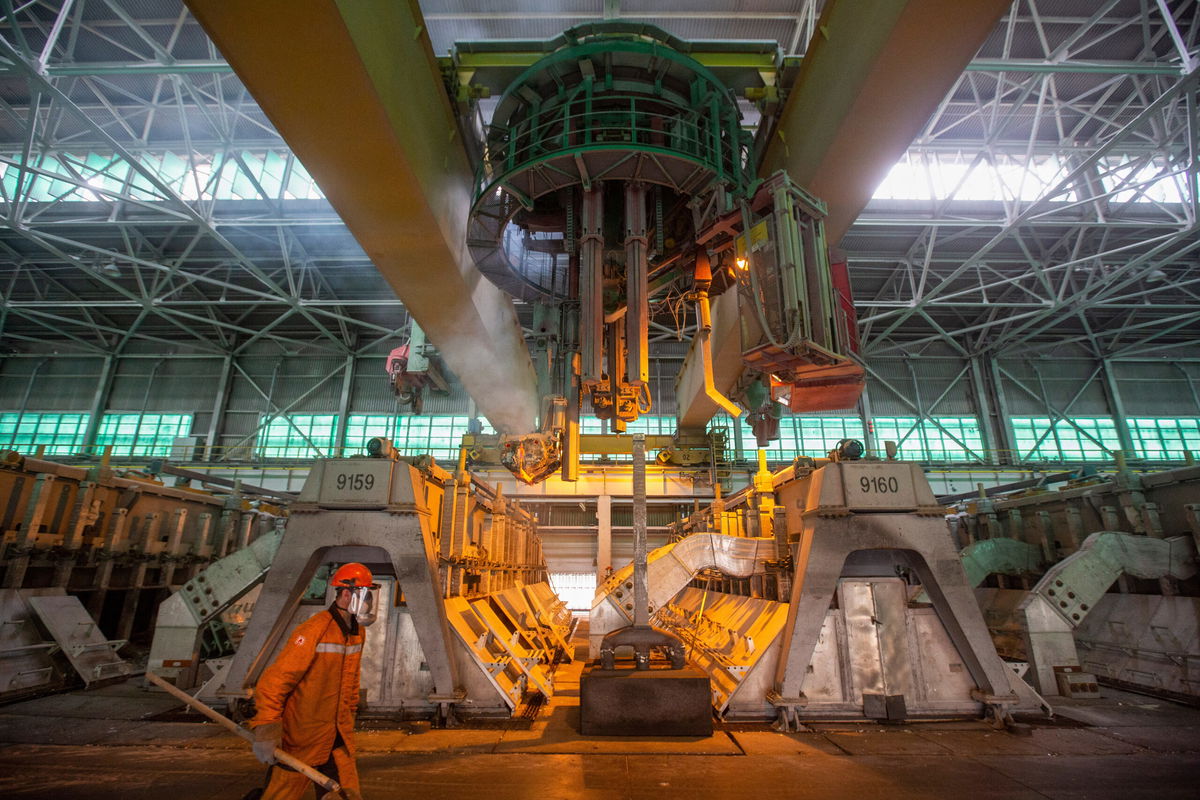 <i>Andrey Rudakov/Bloomberg/Getty Images</i><br/>A worker monitors an electrolysis bath in the electrolysis shop at the Khakas aluminum smelter