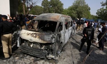 Pakistani investigators examine the site of the explosion in Karachi