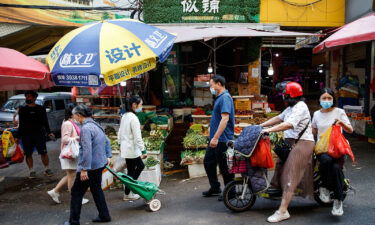 Customers shop at the market on April 9