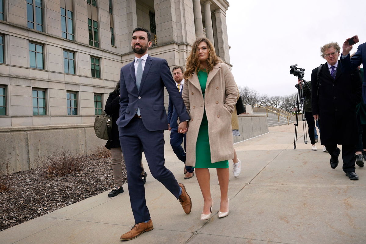 <i>Charlie Neibergall/AP</i><br/>A lawyer for Iowa Senate hopeful Abby Finkenauer urged the state Supreme Court on Wednesday to place her back on this year's Democratic primary ballot. Finkenauer is shown here leaving the state Supreme Court building in Des Moines with her husband