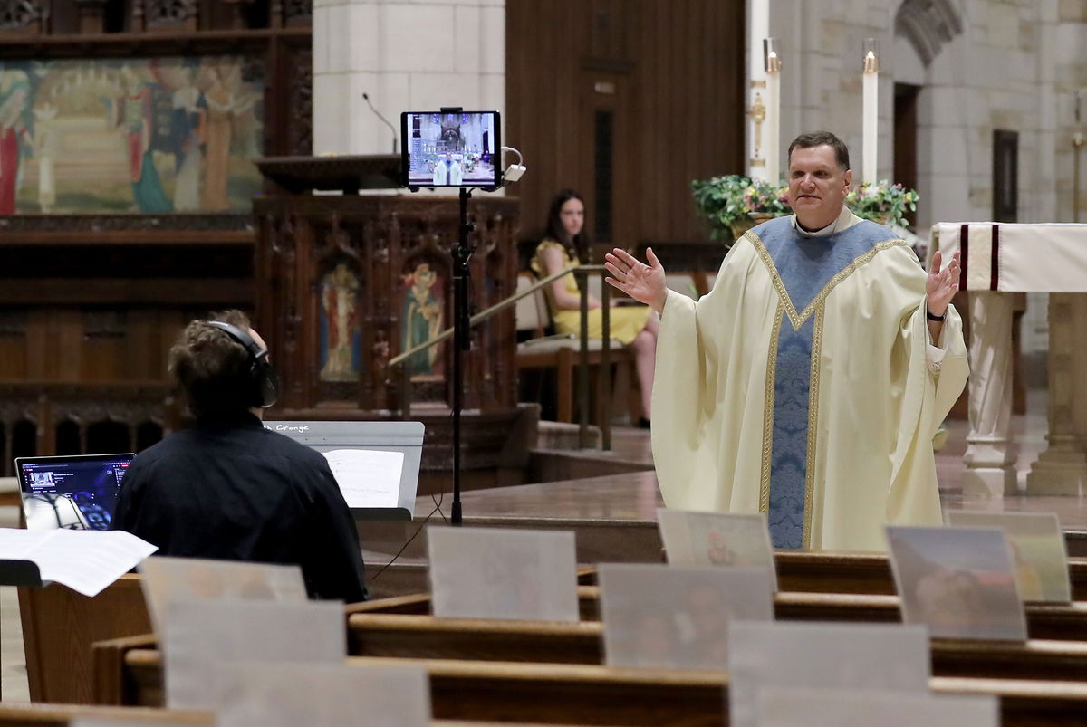 <i>Elsa/Getty Images</i><br/>Rev. Brian X. Needles delivers Easter Sunday Mass via livestream on April 12