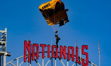 A member of the Army Golden Knights descends into National Park before a baseball game between the Washington Nationals and the Arizona Diamondbacks on Wednesday