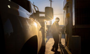 A person finishes pumping gas at a Shell station on April 1