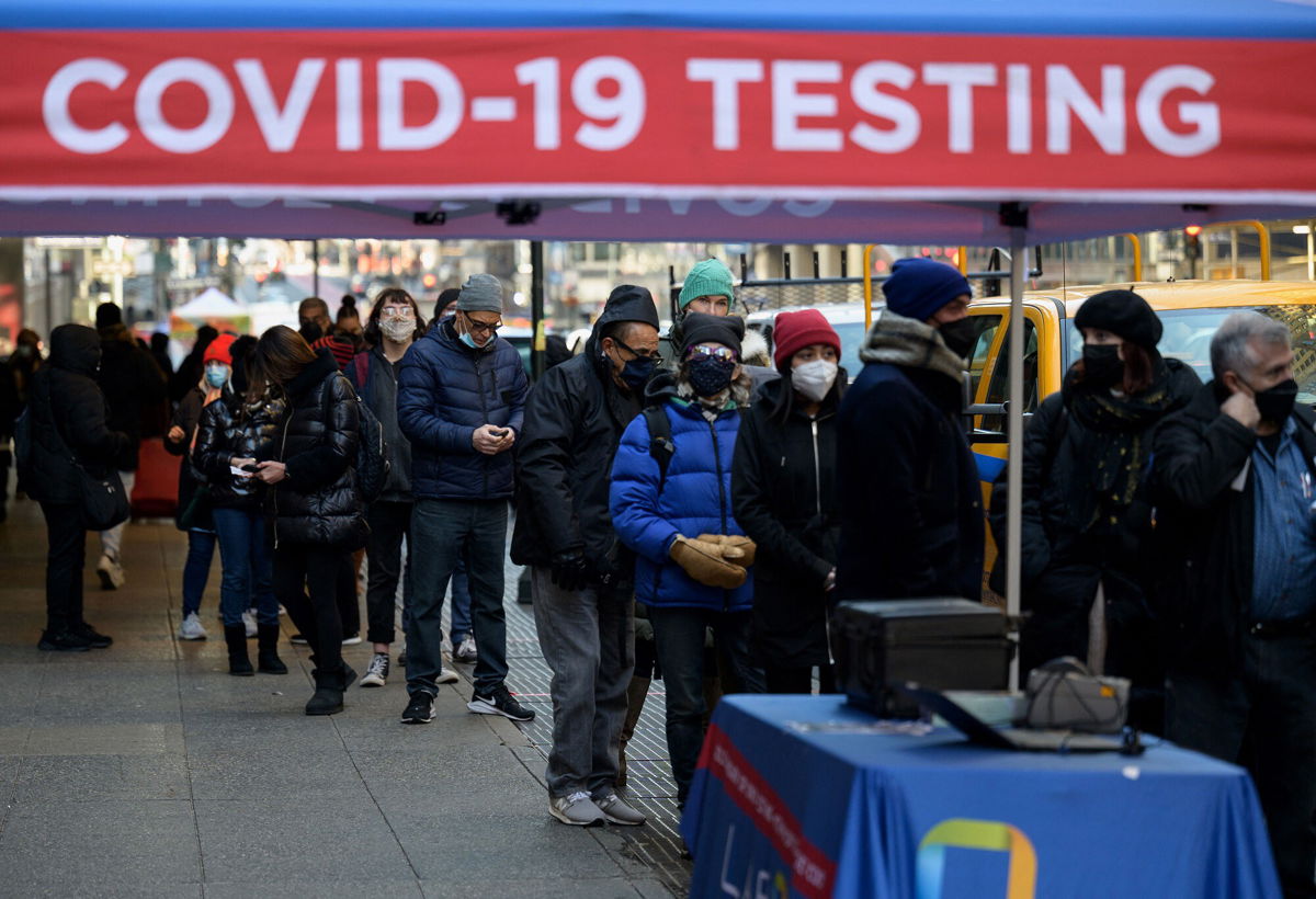 <i>Angela Weiss/AFP via Getty Images</i><br/>People wait in line to receive a Covid-19 test on January 4