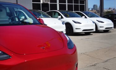 Tesla cars sit in a dealership lot on March 28