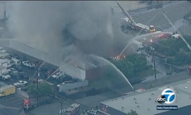 A three-alarm fire erupted Tuesday morning at a commercial building in Los Alamitos