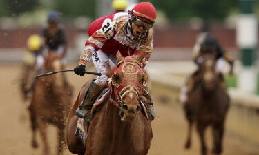 Jockey Sonny Leon rides long-shot Rich Strike over the finish line at the Kentucky Derby on May 7.