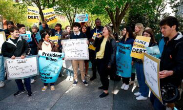 Melissa Byrne joins student debtors to once again call on President Biden to cancel student debt at an early morning action outside the White House with a brass band on April 27 in Washington