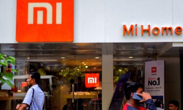 Xiaomi is the latest big Chinese company to face the heat in India. Xiaomi India distributes Mi-branded smartphones. People are here walking past an MI home mobile store in Kolkata