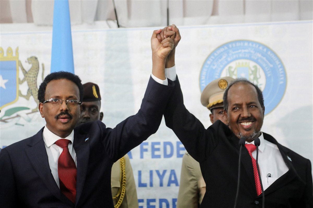 <i>FEISAL OMAR//REUTERS</i><br/>Somalia's newly elected president Hassan Sheikh Mohamud (R) holds hands with incumbent president Mohamed Abdullahi Mohamed (L) after winning the elections in Mogadishu
