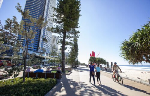 People walk along the Esplanade at Surfers Paradise in Gold Coast