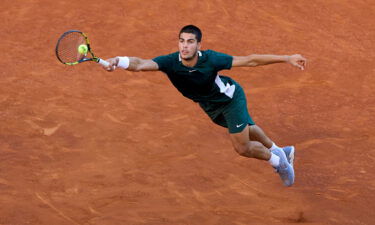 Carlos Alcaraz returns a ball against Alexander Zverev.