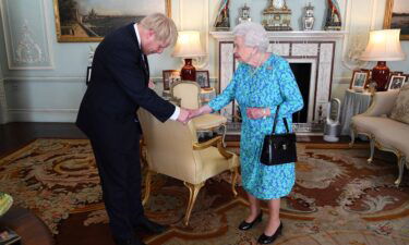 Britain's Queen Elizabeth II welcomes Johnson