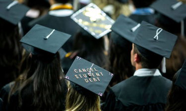 A University of Iowa graduate wears a cap with the words "Cancel student debt" during a commencement ceremony in Iowa City on May 14.