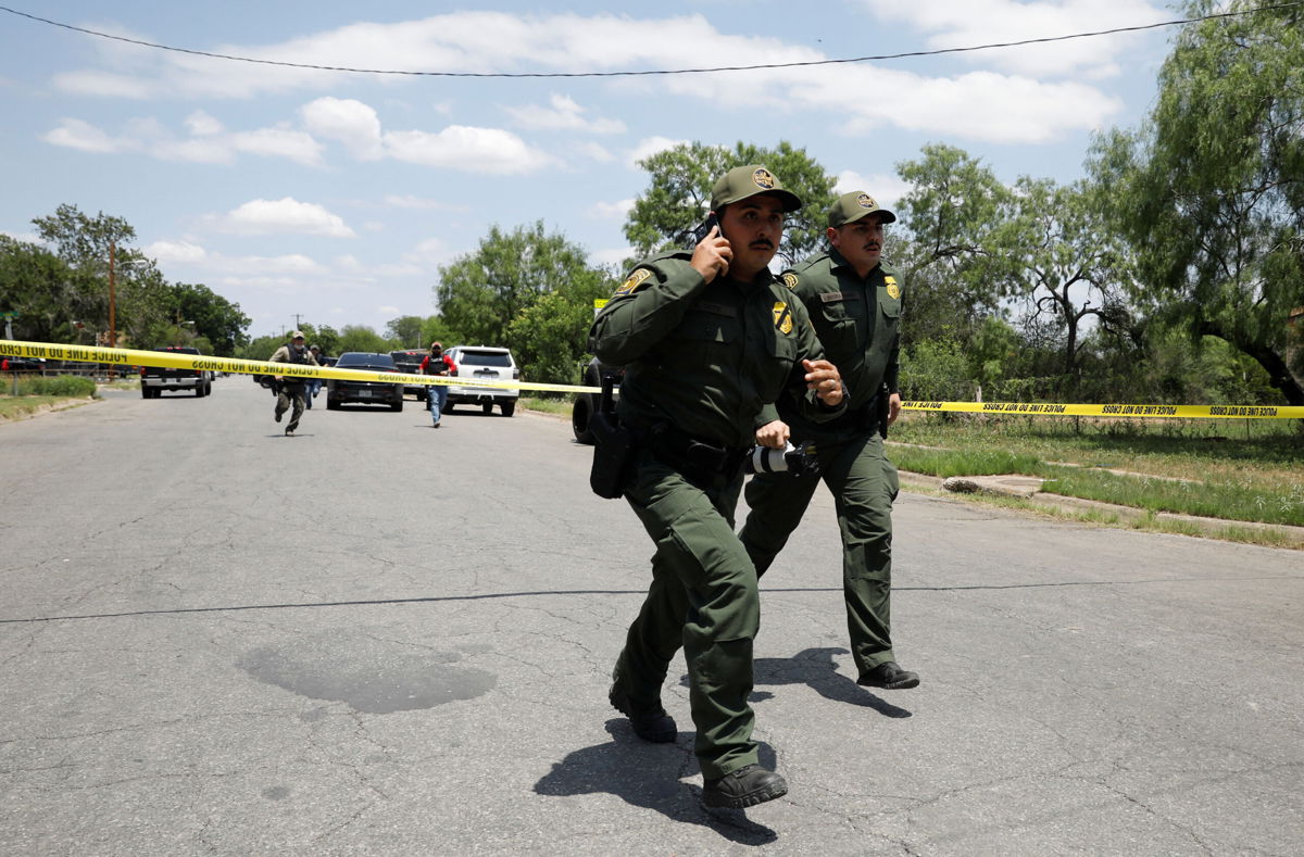 <i>Marco Bello/Reuters</i><br/>Law enforcement personnel near the scene of the shootings at Robb Elementary School in Uvalde