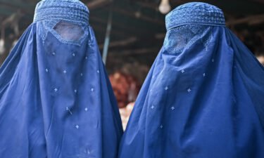 Taliban decree orders women in Afghanistan to cover their faces. Afghan burqa-clad women are pictured at a market in Kabul on December 20