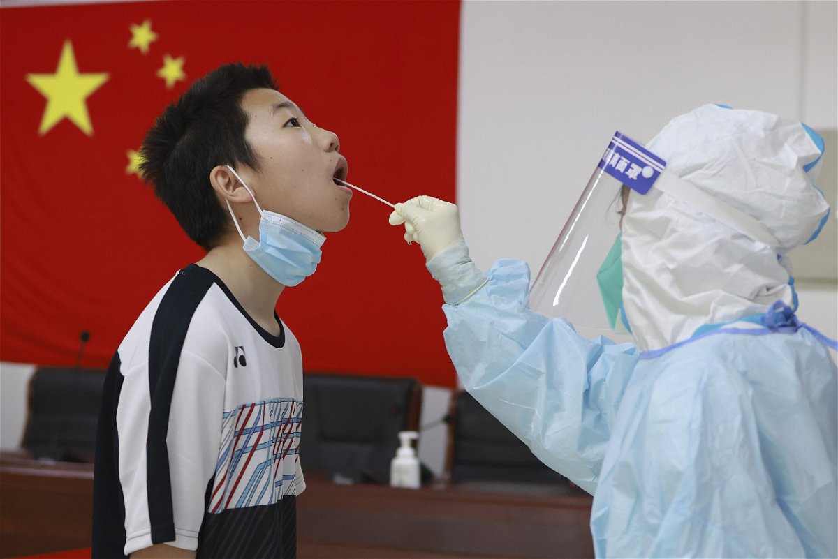 <i>Lintao Zhang/Getty Images</i><br/>A boy receiving a Covid test in Beijing