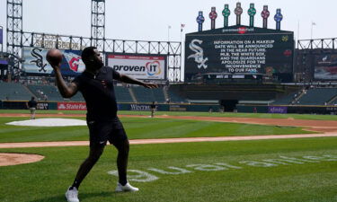 Cleveland Guardians' player Franmil Reyes throws a football to teammate Myles Straw at Guaranteed Rate Field in Chicago on May 11. Due to multiple positive Covid-19 tests within the Guardians organization