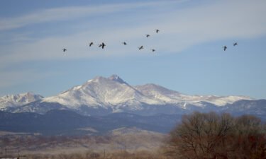 A climber was missing and two others were injured after a rockfall and avalanche on Mount Meeker in Colorado's Rocky Mountain National Park on Sunday morning. Pictured are Longs Peak and Mount Meeker in this 2016 file photo.