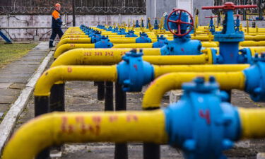 Gas station worker walks near gas pipes at a natural gas station during the installation of complex gas preparation at the Ukrgasvydobuvannya UCPG facility.